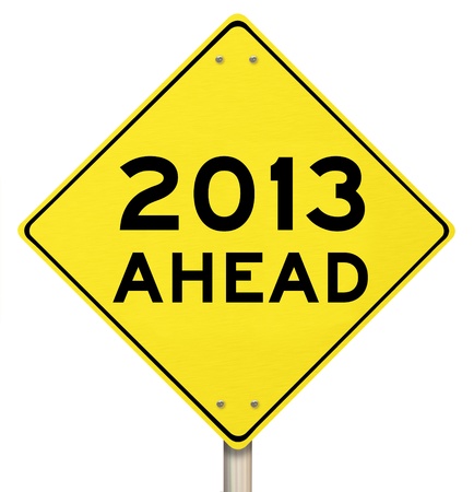 The words 2013 Ahead on a yellow yield sign to mark the challenges and opportunity and hopes for a...