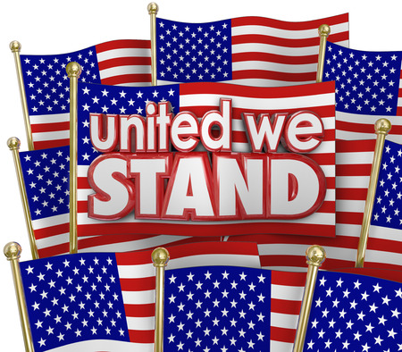 United We Stand words of solidarity and unity on American or USA flags waving in patriotic pride as a symbol of sticking together through thick and thinの写真素材