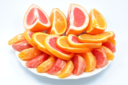 grapefruit and oranges on a plateの写真素材
