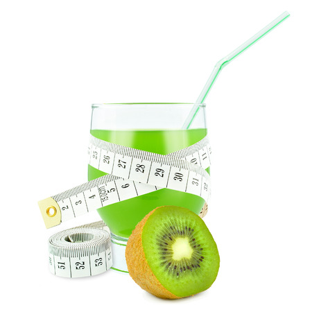 glass of juice with kiwi and meter isolated on white の写真素材
