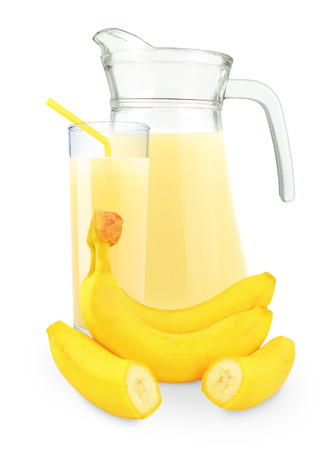 banana juice in a glass and jug on a white background の写真素材