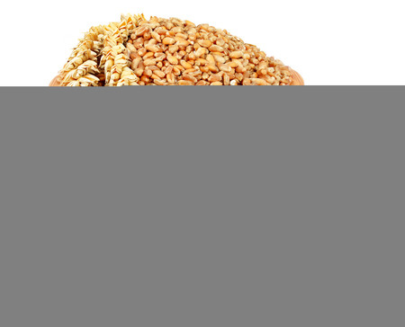 Wheat in a wooden bowl isolated on whiteの写真素材