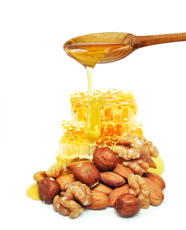 nuts and honey dripping isolated on a white backgroundの写真素材
