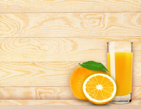 orange juice in a glass on a wooden backgroundの写真素材