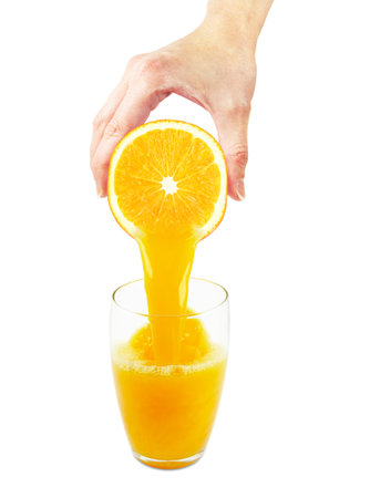 hand squeezing orange juice isolated on white backgroundの写真素材