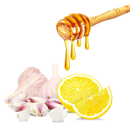 dripping honey, garlic and lemon isolated on white backgroundの写真素材
