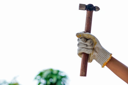 hands wear gloves holding a hammer with blurry in the background, happy labour day. International...