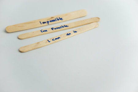 handwriting messages on ice cream sticks in close-up as a concept for building self-esteemの写真素材
