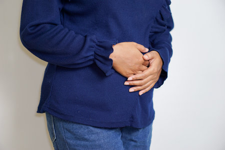 portrait of Asian woman experiencing menstrual pain holding sanitary napkin