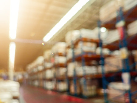 Blurry background of Warehouse inventory product stock for logistic background, global business for good import and export, stock storage industrial delivery, logistic factoryの写真素材