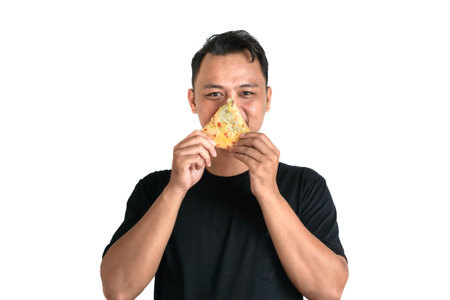 A man in a black shirt smiles while holding a flavorful slice of food. The plain white background emphasizes his joyful expression and the vibrant colors of the food.の写真素材