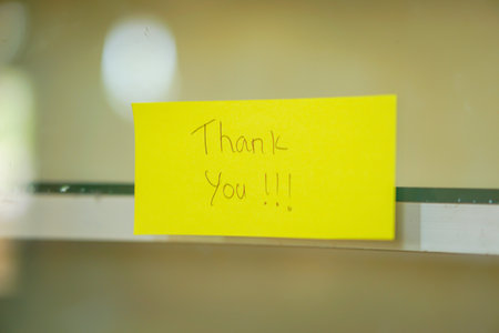 A cheerful note saying "Thank You" on a bright yellow sticky note, enhancing positivity in any space.の写真素材