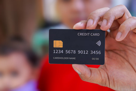 a close-up view person holding a credit cardの写真素材