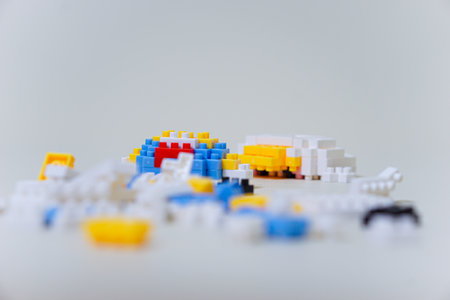 A colorful assortment of building blocks scattered on a surface, inviting creativity.の写真素材