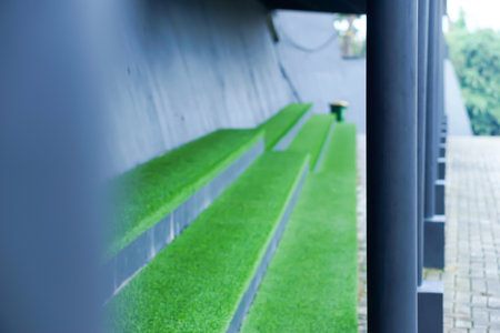 A seating area with vibrant green grass and modern design elements.の写真素材