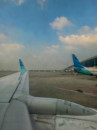Airplane wing view at airport.の写真素材