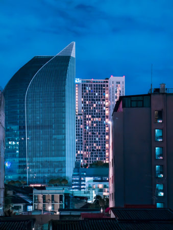 Cityscape at night with illuminated buildings.の写真素材