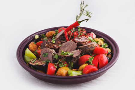 A dish of grilled meat with vegetablesの写真素材