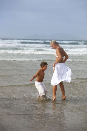 Happy Mother and son play on the beachの写真素材