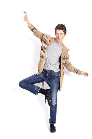 Young man balancing isolated over a white backgroundの写真素材