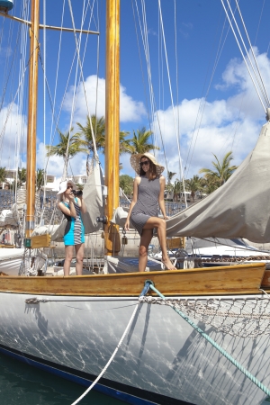 Young woman take a picture her friend on sailboatの写真素材