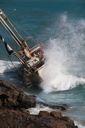 yacht crash on the rocks after stormy weatherの写真素材