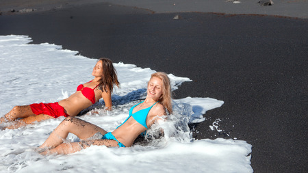 Two  Beauty  on the  Beach with black sandの写真素材