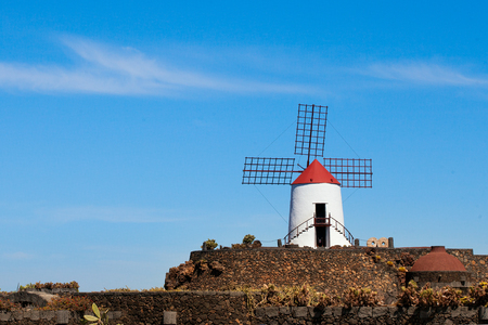 Windmill in cactus garden in Lanzarote, Spainの写真素材
