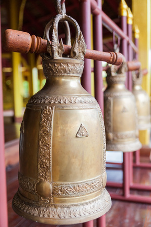 Buddhist bells hanging in templeの写真素材