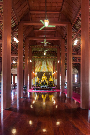 Golden Buddha statue in wooden templeのeditorial素材