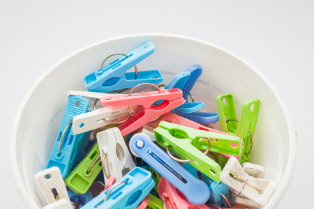 Clothespins in plastic bucketの写真素材