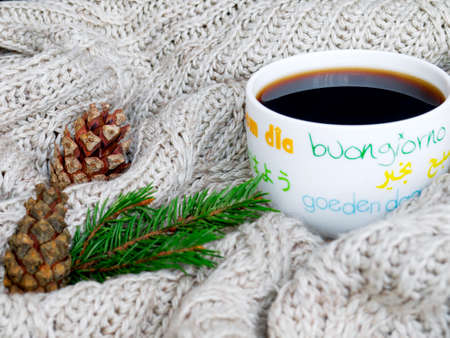 Cup of hot tea, dressed in knitted warm scarf winter warm knitted sweater or blanket. Still scarf...