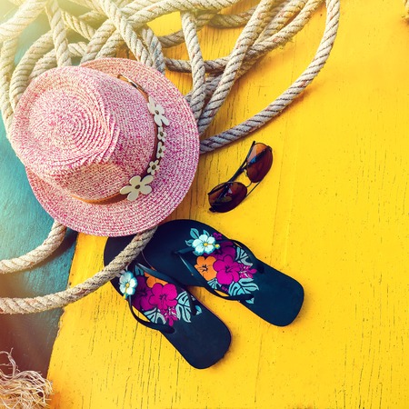 Set of Womans Things Accessories to Beach Season Straw Beach Womans Hat Top View Yellow Background Flat Singleの写真素材