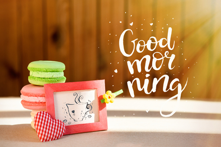 Morning surprise, colored cakes makarons with a card. The inscription is a good morning. Sun raysの写真素材