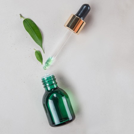 The minimal style. Vegetable extract, essential oil in a vial with pipette. The concept of natural cosmetics. Flat lay.の写真素材