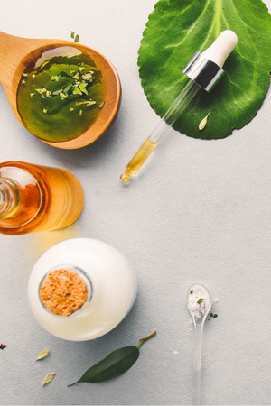 Natural cosmetics, oils for skin care on a light background. Homeopathic oils, whey, milk, soap. Beauty blogger concept.の写真素材