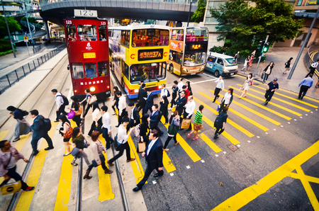 HONG KONG, CHINA - APRIL 29, 2014: Residents of downtown crossing the street at a pedestrian crossing in the afternoonのeditorial素材