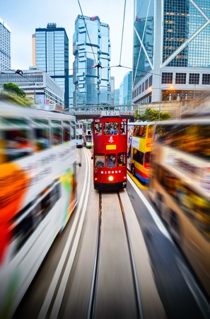 HONG KONG, CHINA - APRIL 29, 2014: Two-story trams on the streets of city in motion. High traffic and speed.のeditorial素材