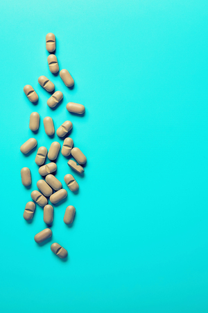 Natural Supplements scattered on a light background.の写真素材