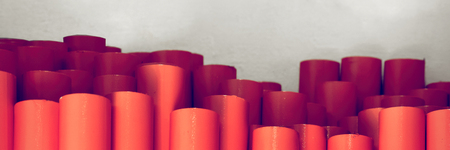 Metal pipes, stand upright. Painted in orange. Concept backgrounds of metal industry. Banner Tonedの写真素材