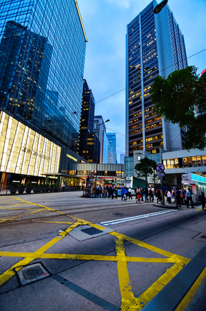 HONG KONG, CHINA - APRIL 29, 2014: The center of Hong Kong in the evening. A busy intersection, people are crossing the road to the George Armani store.のeditorial素材