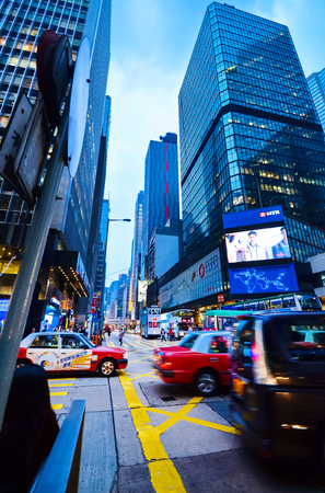 HONG KONG, CHINA - APRIL 29, 2014: Lively roads with skyscrapers, the center of Hong Kong. High traffic in the eveningのeditorial素材