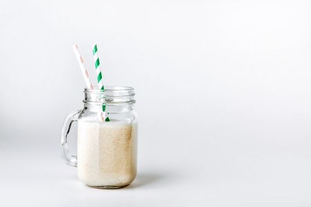 Protein cocktail with milk, vanilla in a glass jar with straws. Sports nutritionの写真素材