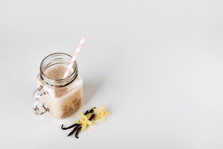 Protein cocktail with milk, vanilla in a glass jar with straws. Sports nutritionの写真素材