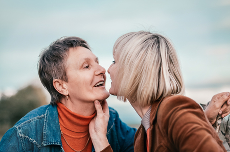 Elderly mother tenderly kissing his daughter. Concept - Maternal love and familyの写真素材