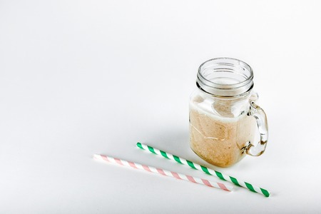 Protein cocktail, smoothie with milk, vanilla in a glass jar with straws.の写真素材