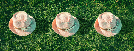 Summer background Pink sunhat on green grass. Pop art design. Bannerの写真素材