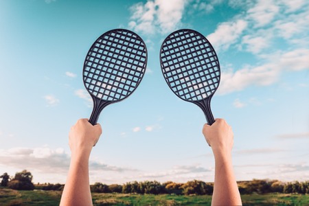 Summer game of badminton or beach tennis against the sky. Concept of summer family entertainmentの写真素材