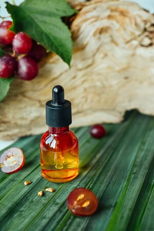 Grape seed oil Still life of bottle with oil, and grape seed, natural backgroundの写真素材