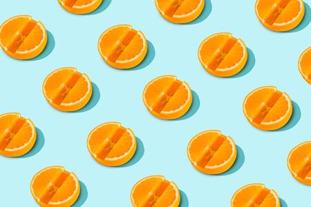 Vitamin C pattern of orange slices in the form of tablets on light blue background. Minimal Health Conceptの写真素材